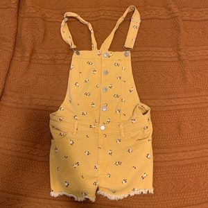 yellow overalls with white flowers
